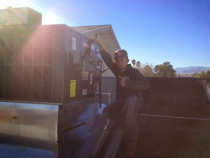 HVAC technician performing HVAC Inspection on a rooftop unit in North Huntingdon